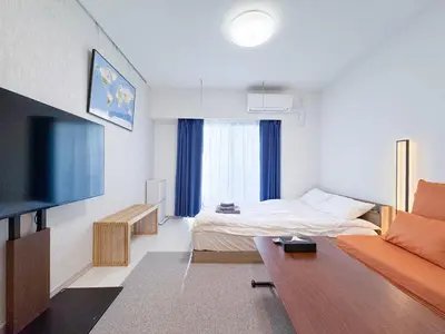 a hotel room with a bed and a couch at Triphome Higahsi Shinjuku Brand New in Tokyo