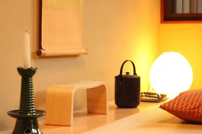 a table with a candle and a candle holder on it at Tsubaki Salon Jujo in Tokyo