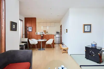 a living room and kitchen with a table and chairs at Tsubaki Salon Jujo in Tokyo