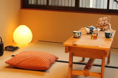 a room with a table and a pillow and a lamp at Tsubaki Salon Jujo in Tokyo