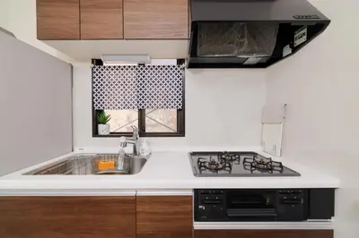 a small kitchen with a sink and a stove at Iriya House \u5165\u8c37\u516c\u5bd3 801 in Tokyo