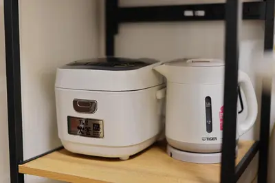 two coffee makers sitting on top of a shelf at Iriya House \u5165\u8c37\u516c\u5bd3 801 in Tokyo