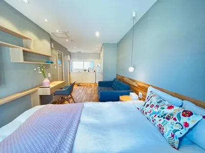 a bedroom with a bed and a blue wall at Shinjuku Waseda Hostel-SJ0147 in Tokyo