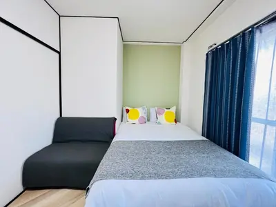 a bedroom with a bed and a window at Shinjuku -JX house SJ0284 in Tokyo