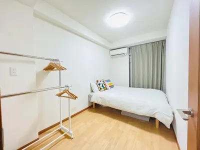 a small bedroom with a bed and a window at Shinjuku -JX house SJ0284 in Tokyo