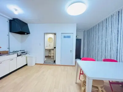 a kitchen and dining room with a table and red chairs at Shinjuku -JX house SJ0284 in Tokyo