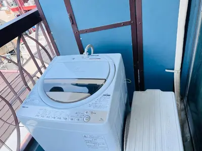a washing machine sitting on top of a balcony at Shinjuku -JX house SJ0284 in Tokyo