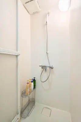 a shower in a white bathroom with a shelf at N1-2Shinjuku luxury house with EV Max6P in Tokyo