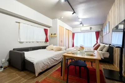a small bedroom with a bed and a table at N1-2Shinjuku luxury house with EV Max6P in Tokyo