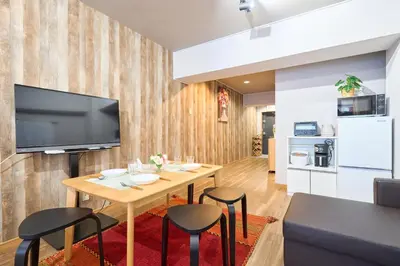 a living room with a table and a television on a wall at N1-2Shinjuku luxury house with EV Max6P in Tokyo