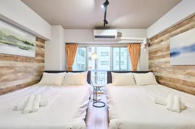 two beds in a room with white sheets at N2-3Shinjuku luxury house with EV Max6P 4min to Sta in Tokyo