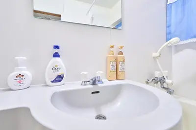a bathroom sink with two bottles of soap and a mirror at N2-3Shinjuku luxury house with EV Max6P 4min to Sta in Tokyo