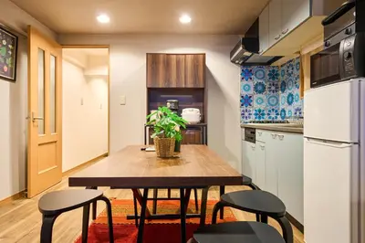 a small kitchen with a wooden table and chairs at N2-3Shinjuku luxury house with EV Max6P 4min to Sta in Tokyo