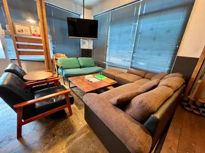 a living room with a couch and a tv at Rakuna Inn \u548c Honjo-Azumabashi in Tokyo