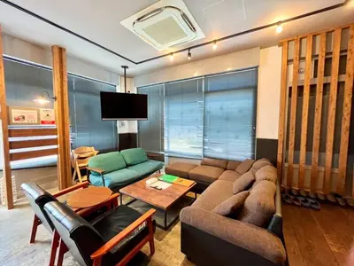 a living room with a couch and a tv at Rakuna Inn \u548c Honjo-Azumabashi in Tokyo