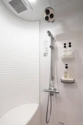 a bathroom with a shower with a shower head at Rakuna Inn \u548c Honjo-Azumabashi in Tokyo