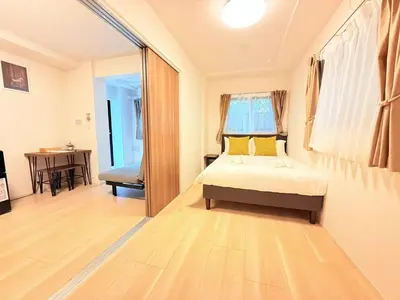 a bedroom with a bed and a desk in a room at Shinjuku Tokyo Holiday Hotel in Tokyo