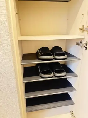 a walk in closet with black and gray shelves at Shinjuku Tokyo Holiday Hotel in Tokyo