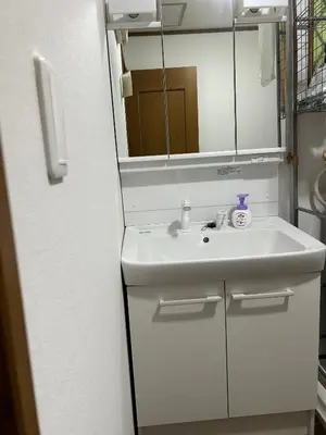 a bathroom with a white sink and a mirror at 120\u5e73\u7c73 5BR House, Near Ueno and Asakusa, Parking 2\u95f4\u6d74\u5ba45\u5ba41\u5385 FlowerTea Hotel in Tokyo