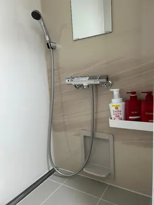 a shower head in the corner of a bathroom at 120\u5e73\u7c73 5BR House, Near Ueno and Asakusa, Parking 2\u95f4\u6d74\u5ba45\u5ba41\u5385 FlowerTea Hotel in Tokyo
