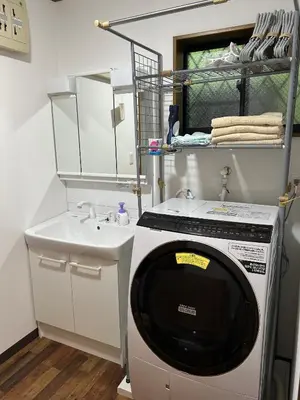 a washing machine in a bathroom with a sink at 120\u5e73\u7c73 5BR House, Near Ueno and Asakusa, Parking 2\u95f4\u6d74\u5ba45\u5ba41\u5385 FlowerTea Hotel in Tokyo