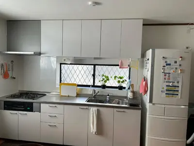 a kitchen with white cabinets and a sink and a refrigerator at 120\u5e73\u7c73 5BR House, Near Ueno and Asakusa, Parking 2\u95f4\u6d74\u5ba45\u5ba41\u5385 FlowerTea Hotel in Tokyo