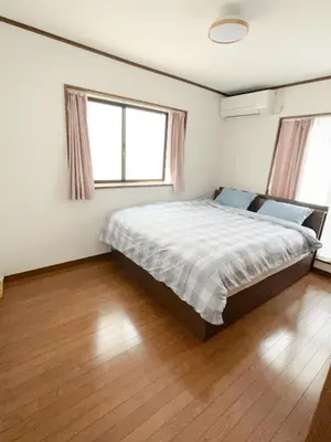 a bedroom with a large bed and two windows at 120\u5e73\u7c73 5BR House, Near Ueno and Asakusa, Parking 2\u95f4\u6d74\u5ba45\u5ba41\u5385 FlowerTea Hotel in Tokyo