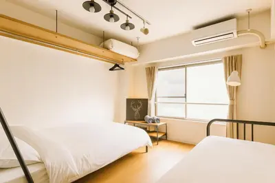 a bedroom with two beds and a window at 203 Modern Comfort in Shinjuku Triple Station Access Free Wi-Fi in Tokyo