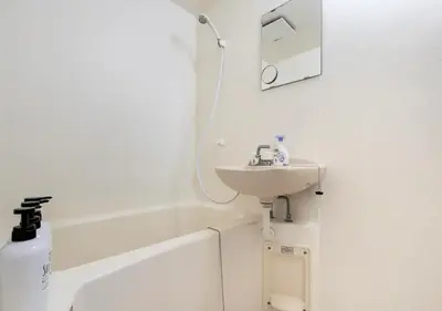 a white bathroom with a sink and a bath tub at 203 Modern Comfort in Shinjuku Triple Station Access Free Wi-Fi in Tokyo