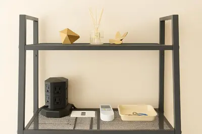 a shelf with a computer and other items on it at 203 Modern Comfort in Shinjuku Triple Station Access Free Wi-Fi in Tokyo