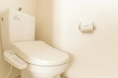 a bathroom with a white toilet and a roll of toilet paper at 203 Modern Comfort in Shinjuku Triple Station Access Free Wi-Fi in Tokyo