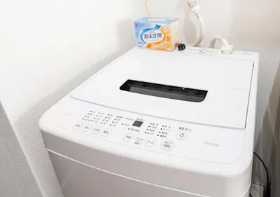 a washing machine with a box on top of it at 203 Modern Comfort in Shinjuku Triple Station Access Free Wi-Fi in Tokyo