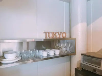 a shelf with cups and glasses on it in a kitchen at Fleg Higashi Azabu in Tokyo