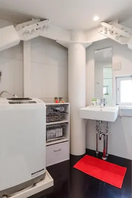 a white kitchen with a sink and a red rug at Fleg Higashi Azabu in Tokyo