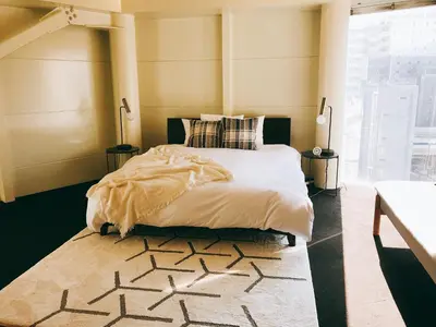 a bedroom with a large bed and a rug at Fleg Higashi Azabu in Tokyo