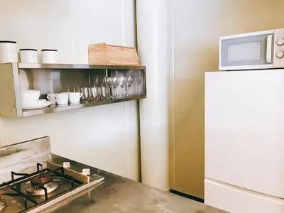 a kitchen with a stove and a refrigerator at Fleg Higashi Azabu in Tokyo