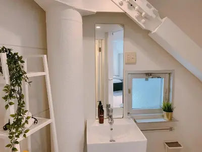 a bathroom with a sink and a mirror at Fleg Higashi Azabu in Tokyo