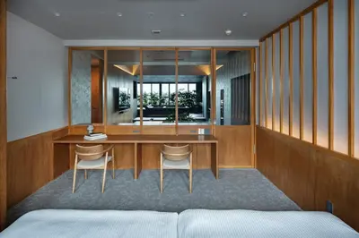 a bedroom with a desk and chairs in a room at YUURO Bath-Living Hotel Ryogoku in Tokyo