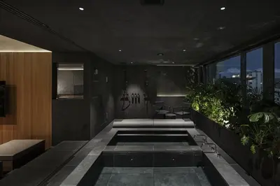 a room with plants and a pool in a building at YUURO Bath-Living Hotel Ryogoku in Tokyo