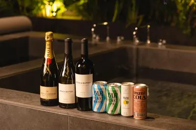 four bottles of wine and cans on a counter at YUURO Bath-Living Hotel Ryogoku in Tokyo