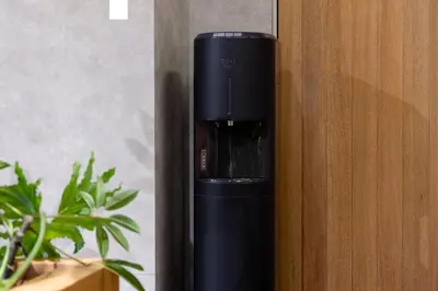 a black coffee maker is sitting on a wall at YUURO Bath-Living Hotel Ryogoku in Tokyo