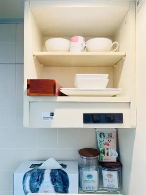 a shelf with plates and bowls in a refrigerator at Alo BnB 12 - Game Universe - Easy Access to Shibuya - New ! in Tokyo