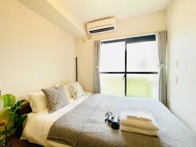 a bedroom with a bed and a large window at Alo BnB 12 - Game Universe - Easy Access to Shibuya - New ! in Tokyo