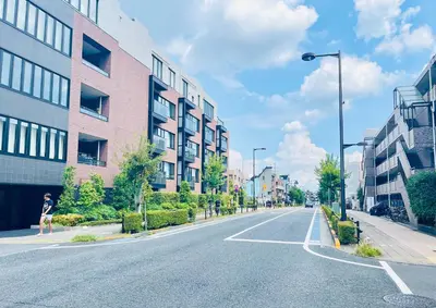 a woman walking down a city street with buildings at Alo BnB 12 - Game Universe - Easy Access to Shibuya - New ! in Tokyo