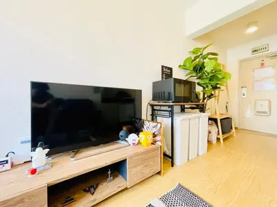 a living room with a large flat screen tv at Alo BnB 12 - Game Universe - Easy Access to Shibuya - New ! in Tokyo