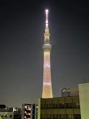 a tall tower is lit up at night at Walk to Asakusa, Sky tree MAX16P in Tokyo