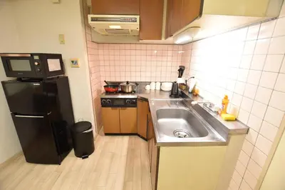 a small kitchen with a sink and a refrigerator at Randor Residence Tokyo Grand in Tokyo