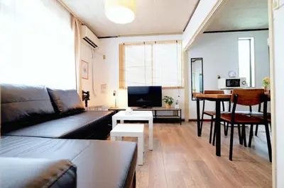 a living room with a couch and a table at Yoyogi New Flats - Vacation STAY 17509 in Tokyo
