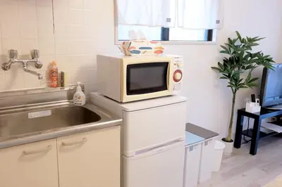 a kitchen with a microwave on top of a counter at Heisei Mansion - Vacation STAY 17520 in Tokyo