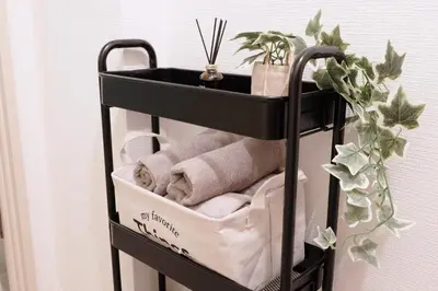 a black towel rack with towels and a plant at Heisei Mansion - Vacation STAY 17520 in Tokyo